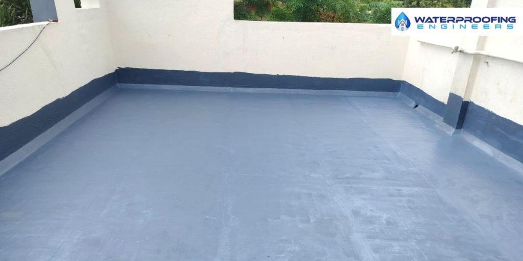 Professional workers applying waterproof coating on terrace